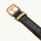 Seagull 1963 Bronze Lume shown with a black leather strap and khaki fabric keeper, strap only, no watch in frame