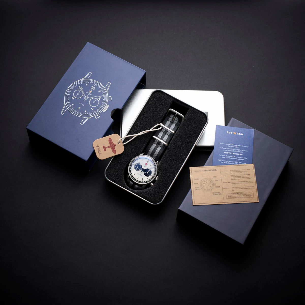 Seagull 1963 White Panda Sport 42mm unboxing flat lay, navy sleeve, silver tin and papers
