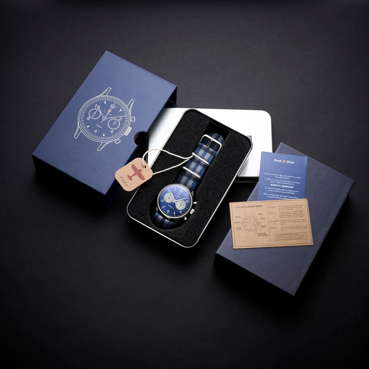 Seagull 1963 Blue Panda 42mm with its navy sleeve, silver tin box and papers laid out on black