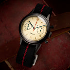 Seagull 1963 Black Edition angled on red leather, black pump pushers and knurled black crown in view