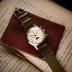 Seagull 1963 Moonphase Cream lying flat across a worn red book over an open Chinese text