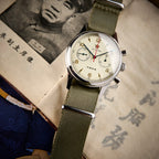 Seagull 1963 Air Force Cream 40mm flat on an old Chinese page, boxed sapphire catching the light