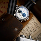 Seagull 1963 White Panda Sport 42mm tucked into a brown leather pouch on a printed page
