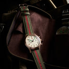Seagull 1963 Bronze Lume 40mm on its strap inside an open brown suede zip pouch