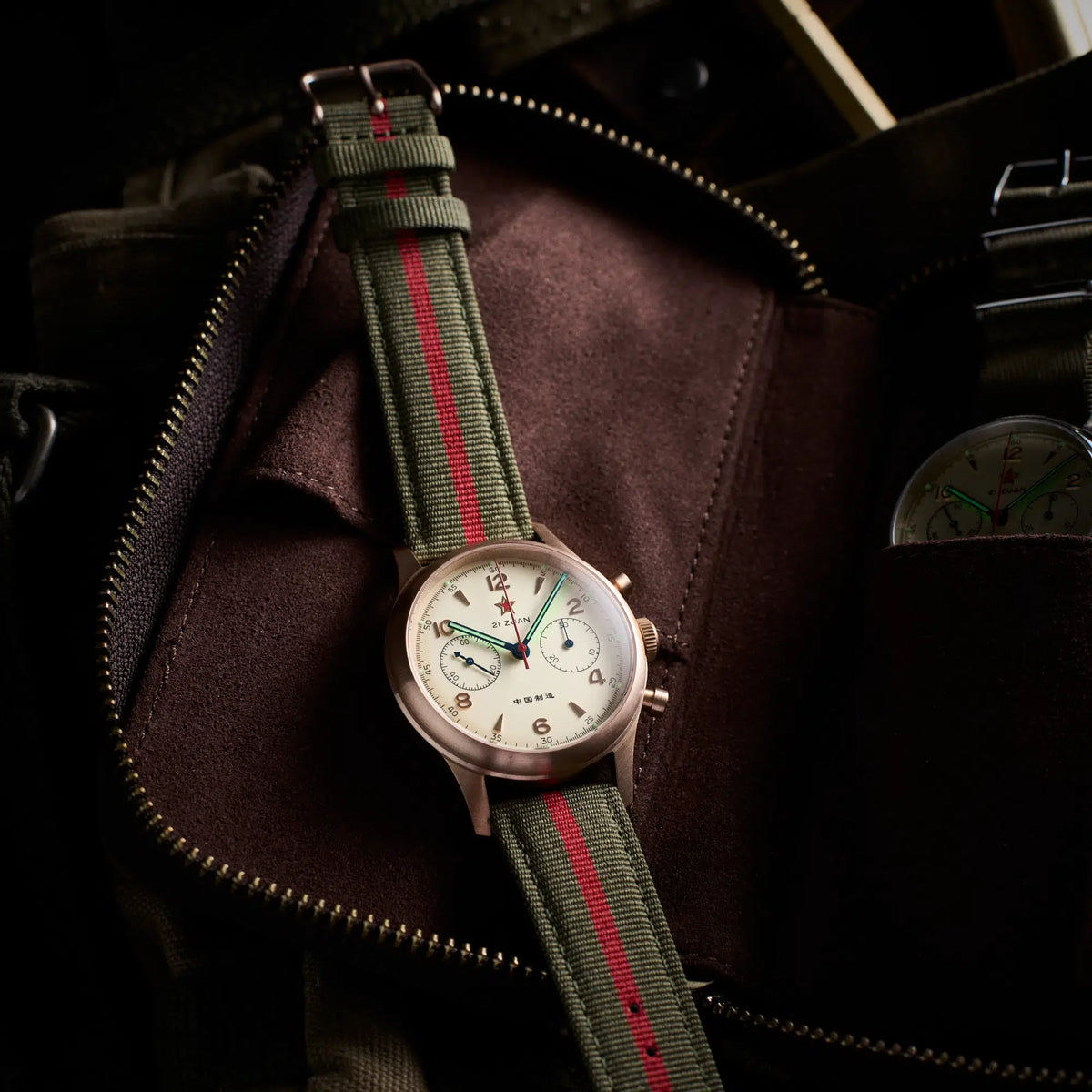 Seagull 1963 Bronze Lume 40mm on its strap inside an open brown suede zip pouch
