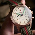 Seagull 1963 Bronze Lume 40mm dial held between fingers, bronze numerals and brushed case flank