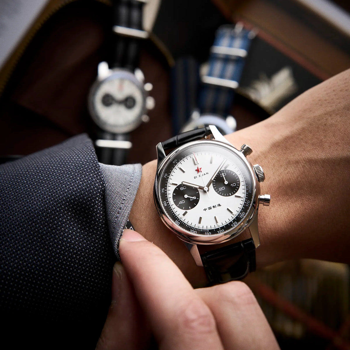 Seagull 1963 White Panda 40mm worn under a grey jacket sleeve on its black croc-embossed strap