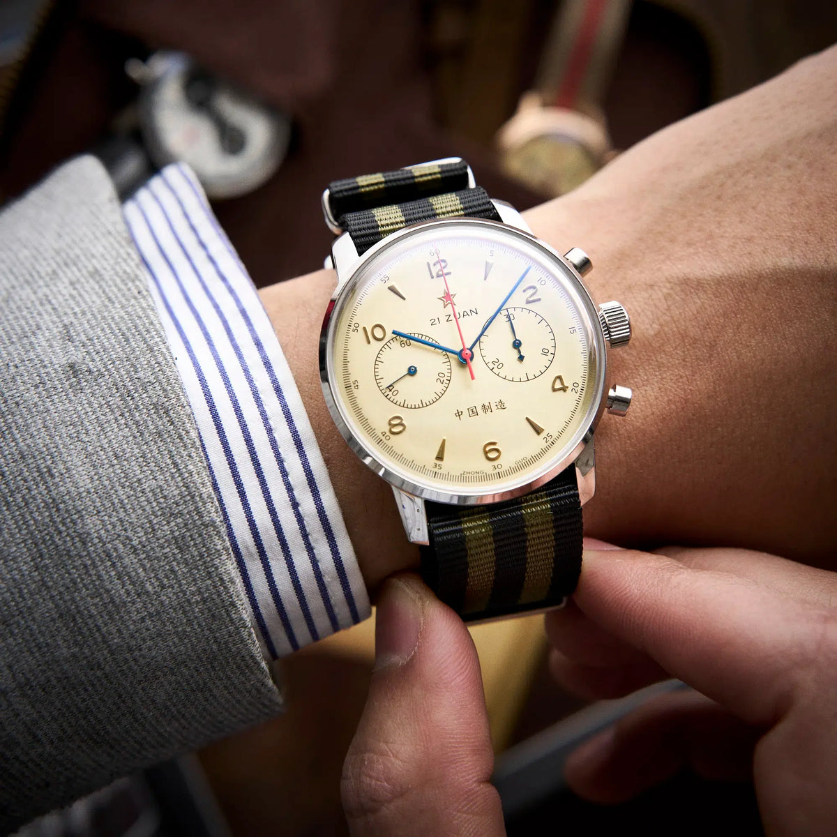 Seagull 1963 Air Force Cream 42mm on the wrist under a striped shirt cuff and grey jacket sleeve