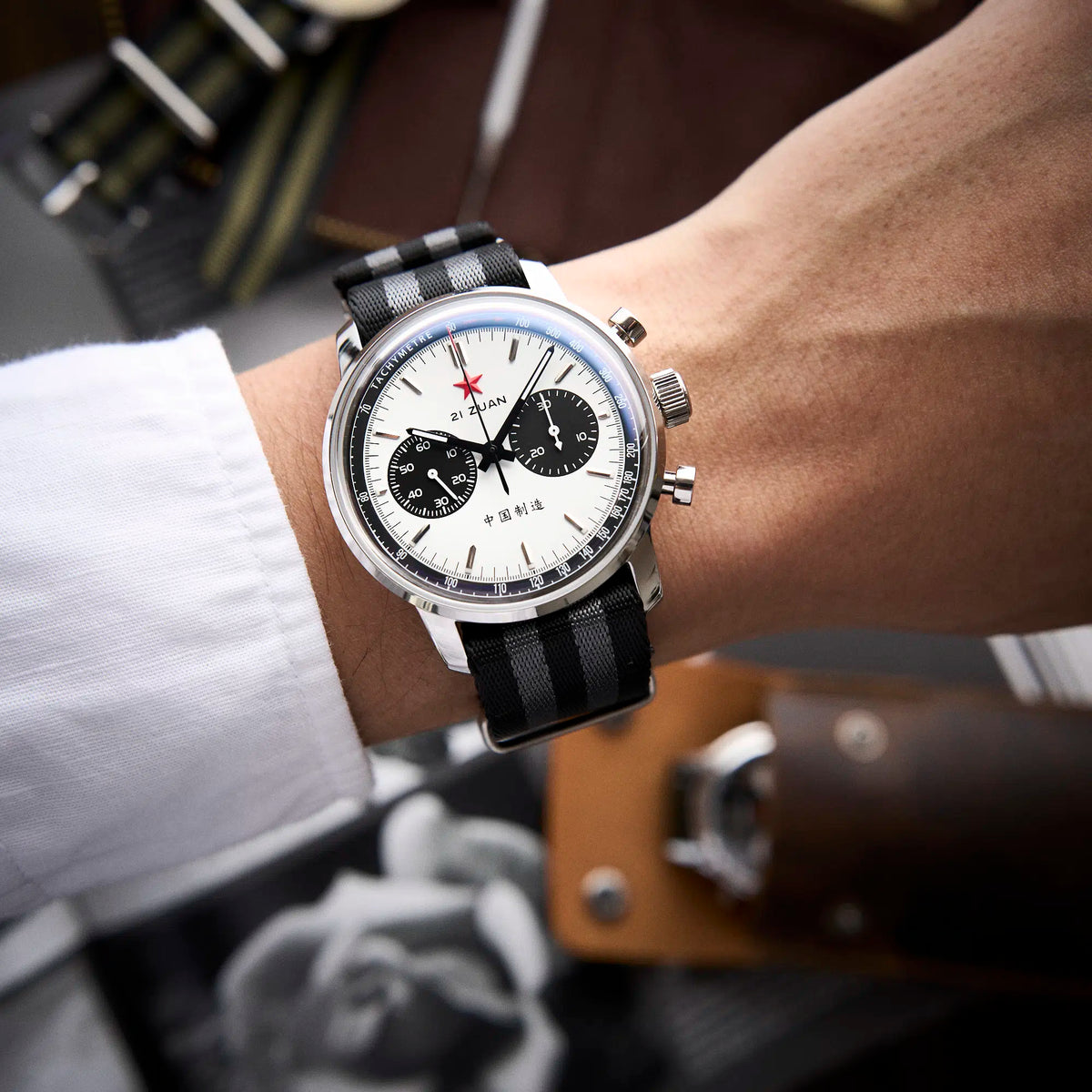 Seagull 1963 White Panda Sport 42mm on the wrist under a white shirt cuff, striped nylon strap