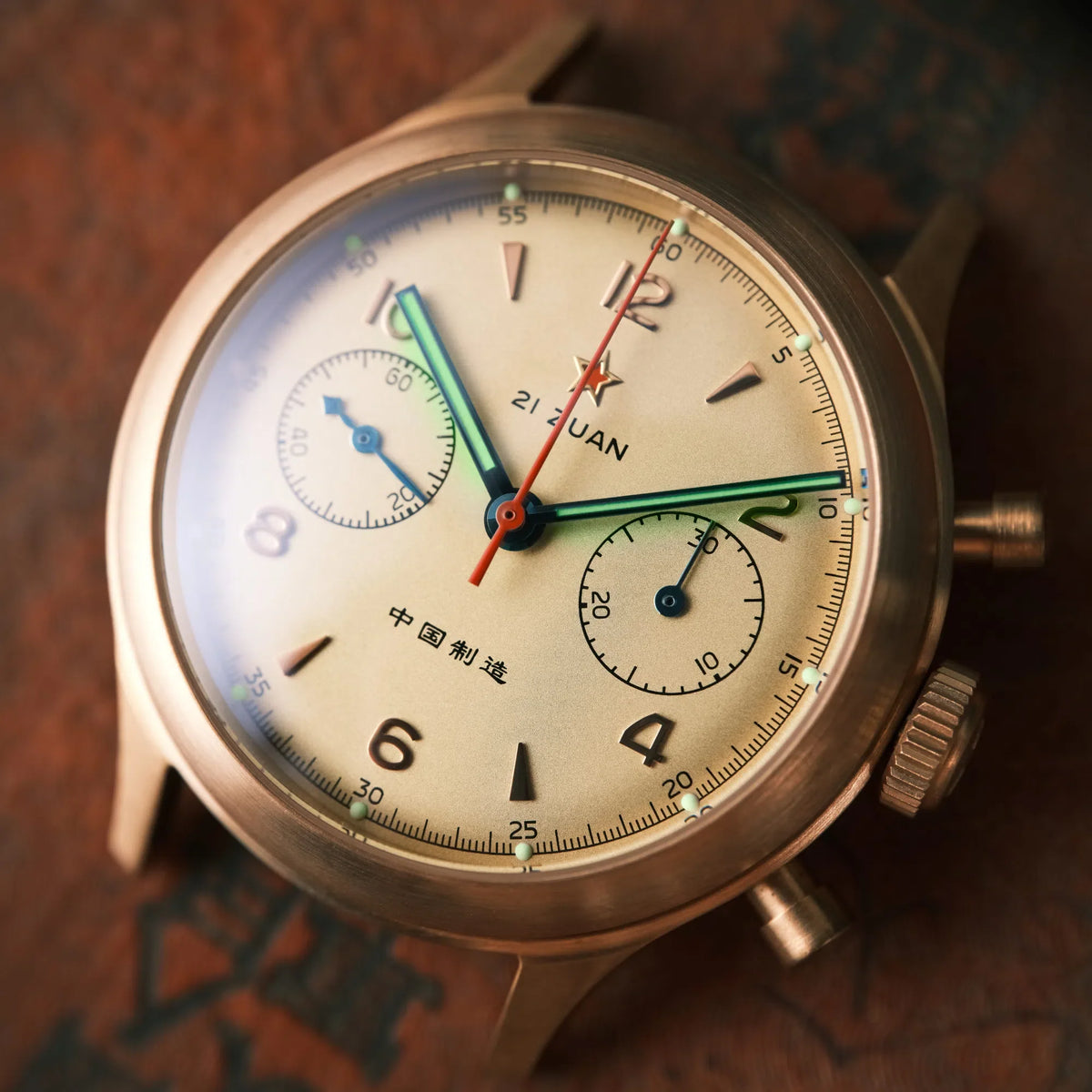 Seagull 1963 Bronze Lume dial close-up at an angle, lume dots at each hour, brushed bronze case, no strap