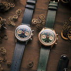 Seagull 1963 Icon II Blue beside the green bronze version on wood with loose watch parts