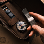 Seagull 1963 Icon II Blue in the suede travel case beside a spare navy leather strap and buckle
