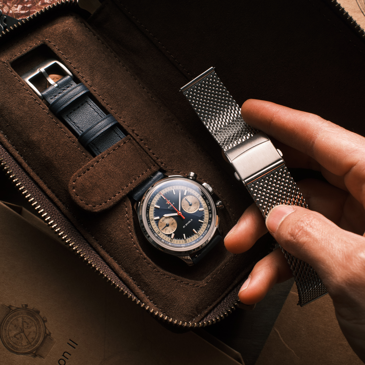 Seagull 1963 Icon II Blue in the suede travel case beside a spare navy leather strap and buckle