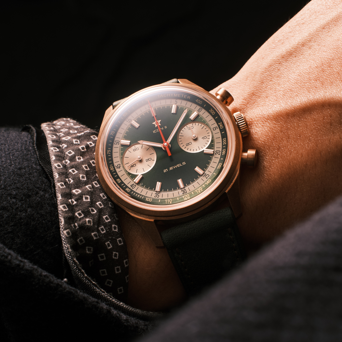 Seagull 1963 Icon II Green on the wrist against a dark background, green leather strap, box crystal