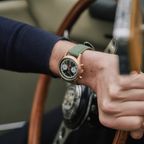 Seagull 1963 The Icon bronze worn at the wooden steering wheel of a classic car